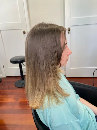 Long straight hair with a soft ombré from brunette roots to blonde ends