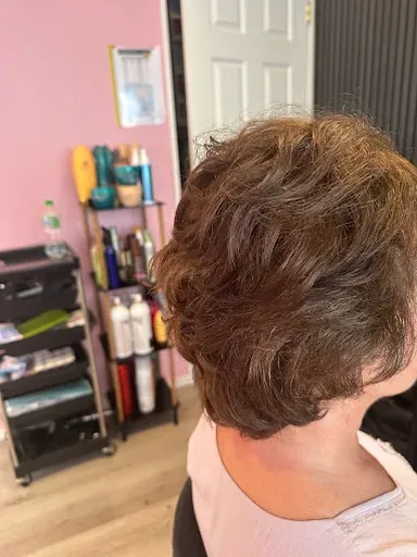 Short brunette haircut styled with soft texture and natural waves
