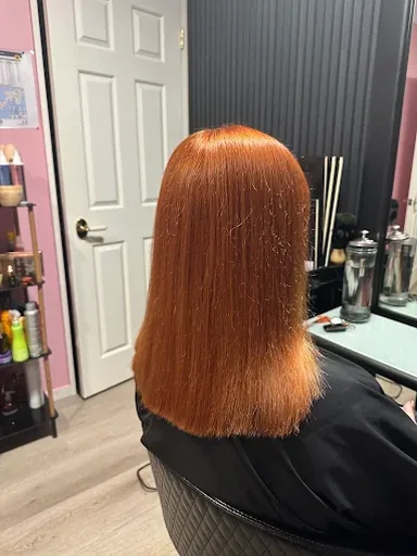 Shoulder-length hair coloured a rich copper red
