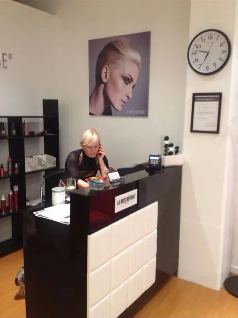Yulia on the phone at the reception desk of the Remuera salon